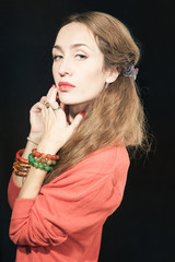 Portrait of a beautiful young woman with red manicure