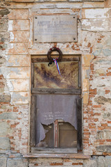 Old window on dilapidated school