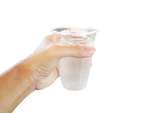 A hand holding a plastic cup of water isolated on white background

