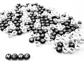heap of round letters black and white and news word