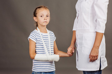 Fototapeta premium doctor pediatrician holds the hand of a small girl patient .