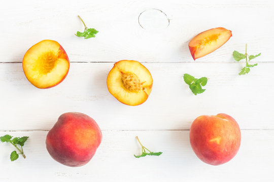 Fresh peaches on white background, top view, flat lay