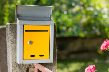 Yellow mailbox in front of the house