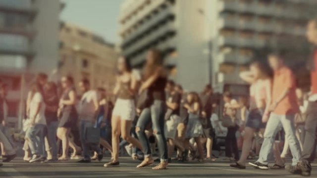 City crowd of pedestrians on summer day cross busy intersection