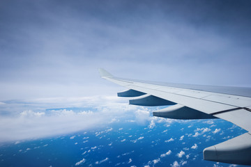 Fototapeta premium Aircraft wing flying over clouds.
