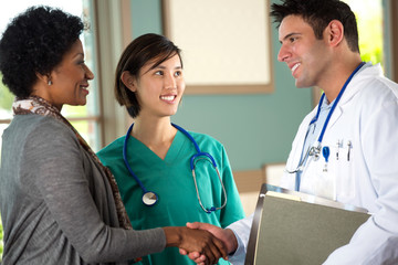 Health care team speaking with a patient.