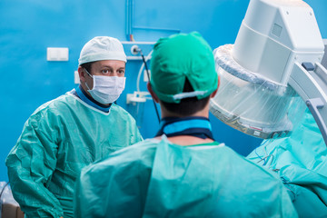 Orthopedic team in the operating room performing spine surgery.