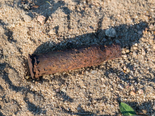 rusty bullet shell on sand