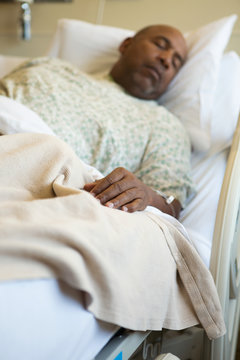 African American man in a hospital bed.