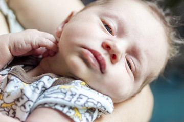 newborn child relaxing on mother&acute;s hands