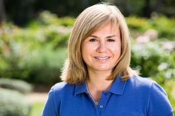 portrait of mature woman in garden .