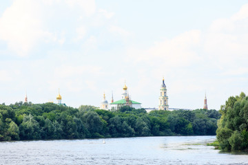 The Orthodox Church stands on the banks of the river, summer, tr