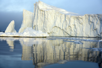 Icebergs are on the arctic ocean on sunset time with shadow