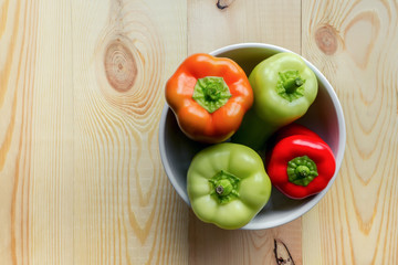 Sweet bell peppers on wooden background. Top view