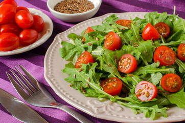 Healthy Breakfast with arugula and cherry tomatoes.