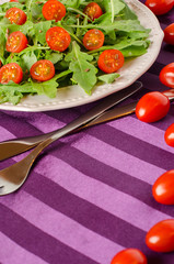 Healthy Breakfast with arugula and cherry tomatoes.