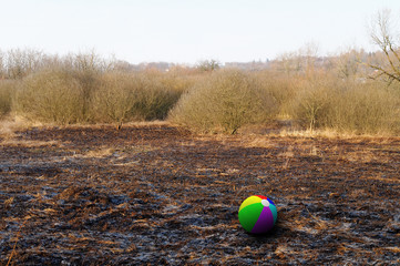 colorful ball on the burnt grass field