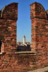 San Zeno Basilica viewed through Scaliger Bridge medieval battlement, in Verona