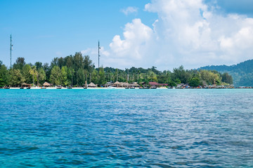 Island blue indigo sea with resort on beach, most abundant coral reef at lipe island,thailand