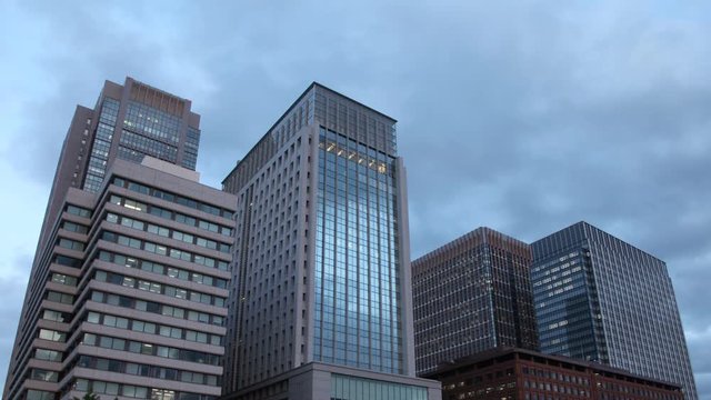 Time Lapse of a clouds moving behind a group of office buildings. Shot in Tokyo, Japan.