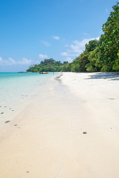 Long tail wooden boat anchor with csytal sea white sand at lipe island,andaman,thailand