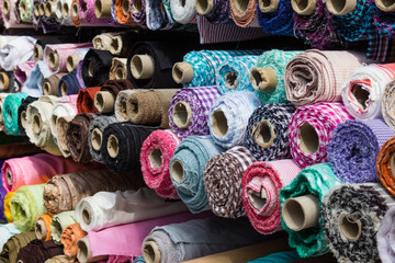 fabric rolls at market stall ,  textile industry background