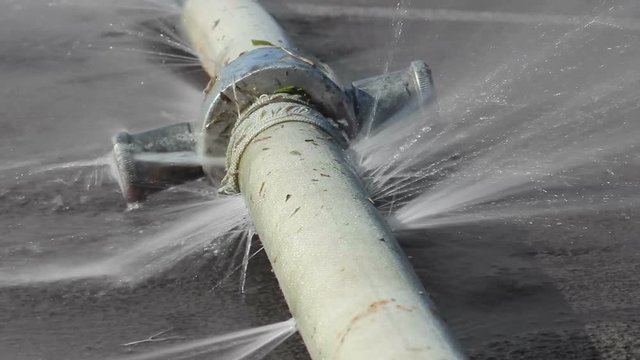 Seamlessly looping water leaking from hole in a industrial hose.