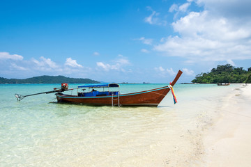 Fototapeta na wymiar Long tail wooden boat anchor with csytal sea white sand at lipe island,andaman,thailand