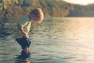 Boy Wading into Lake