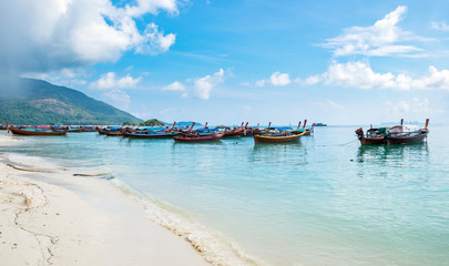 Crystal sea beach with group long tail boat anchor coast at lipe island