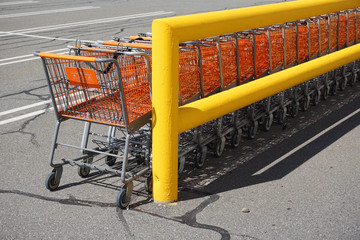 stacking shopping carts in parking lot outside store