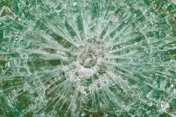 Bulletproof glass after the shooting with traces of bullets, test