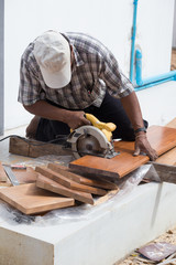 carpenter use electric saw to sawing wood