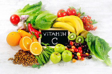 Foods High in vitamin C on wooden board.