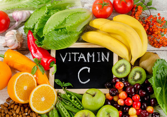 Foods High in vitamin C on wooden board.  Healthy eating.