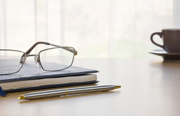 Glasses and book on the desk