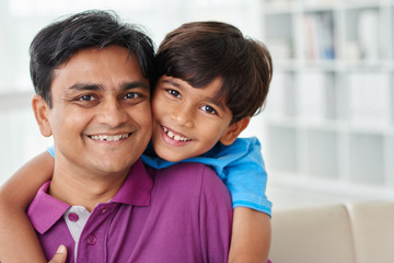 Portrait of smiling dad and his kid at home