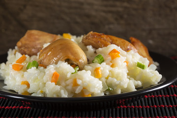 Plate of rice with fried chicken and vegetables