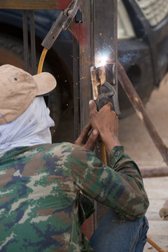 Welder working a welding metal.