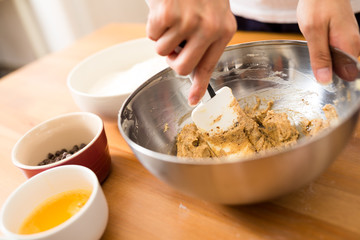 Woman mixing the dough for making cookies
