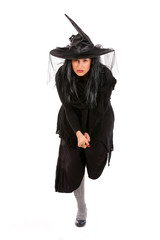 young black dressed witch with broom, isolated on white background