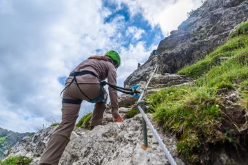 Gordijnen Hiker climbing in the mountain of Alps, Europe © Simon Dannhauer