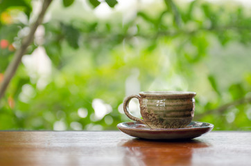 Hot coffee cup on the wooden table in coffee shop