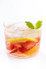 lemonade with strawberry and lemon on white background, closeup