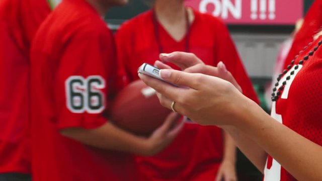 Tailgate: Woman Texting On Phone From Party