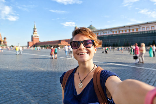 young attractive woman traveler makes selfie on the mobile phone