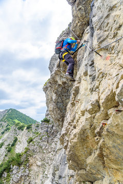 Hiker climbing in the mountain of Alps, Europe