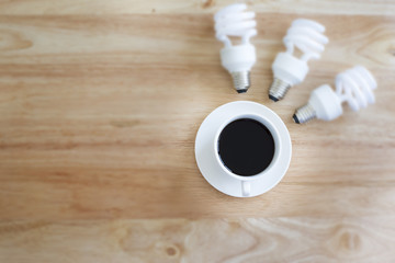 Black coffee in selective focus And blurry lamp. on wood table.