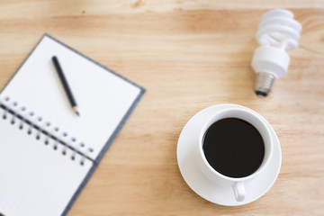 Black coffee in selective focus on blurry wood table with blurry