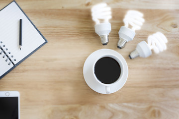 Black coffee in selective focus on blurry wood table with blurry